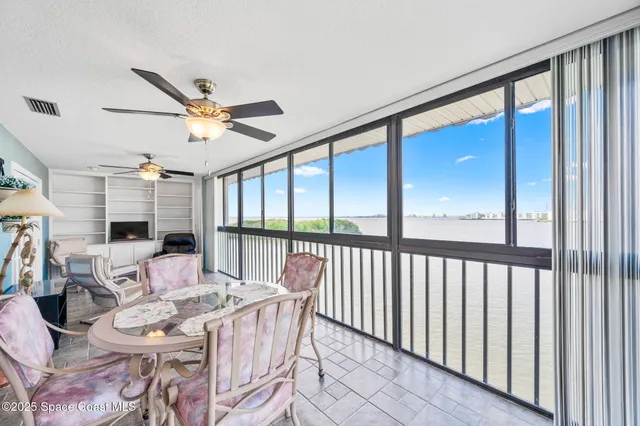 a dining room with furniture window and wooden floor