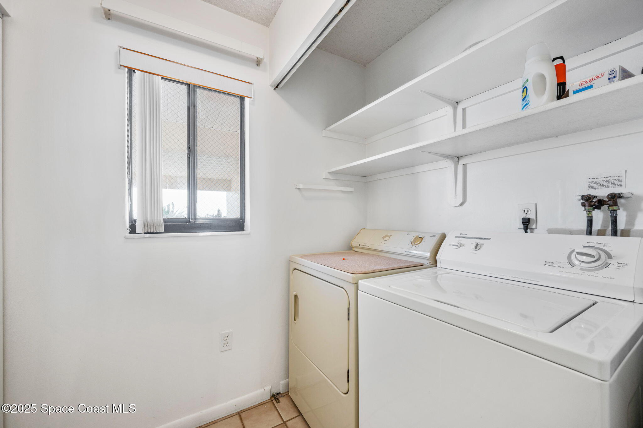 200 South Banana River Boulevard, Unit 2424 Cocoa Beach, FL 32931 - Photo 16 of 18 a utility room with dryer and washer