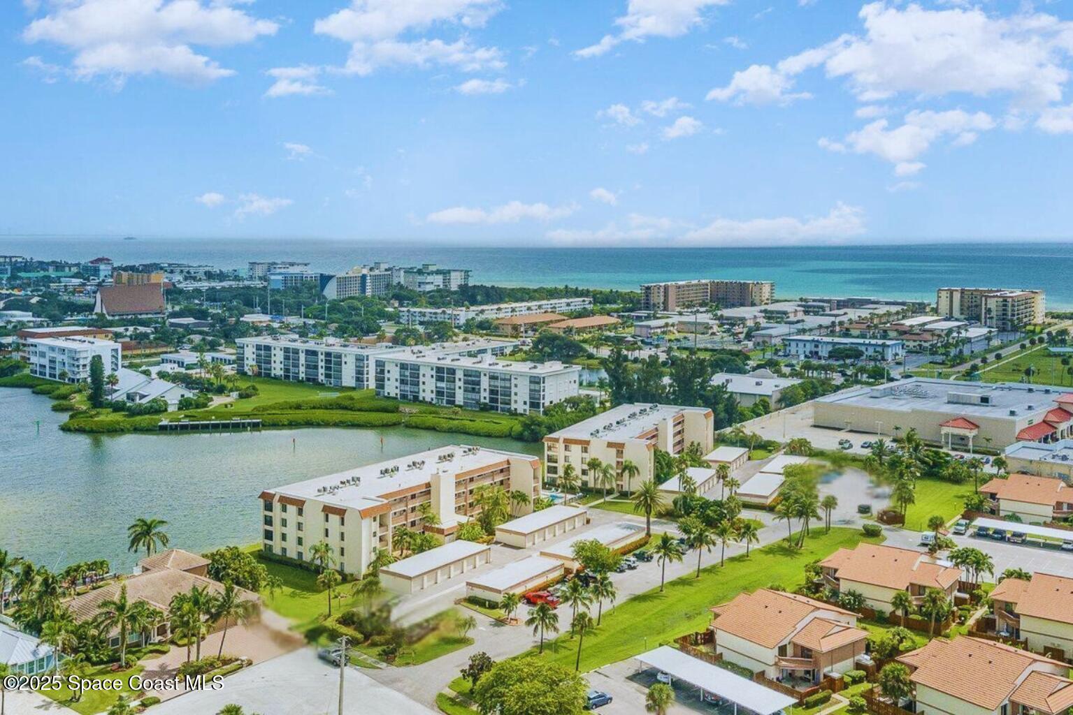 200 South Banana River Boulevard, Unit 2424 Cocoa Beach, FL 32931 - Photo 17 of 18 an aerial view of a city with lots of residential buildings lake and ocean view