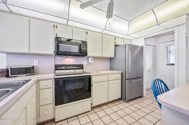 a kitchen with cabinets stainless steel appliances and a counter space