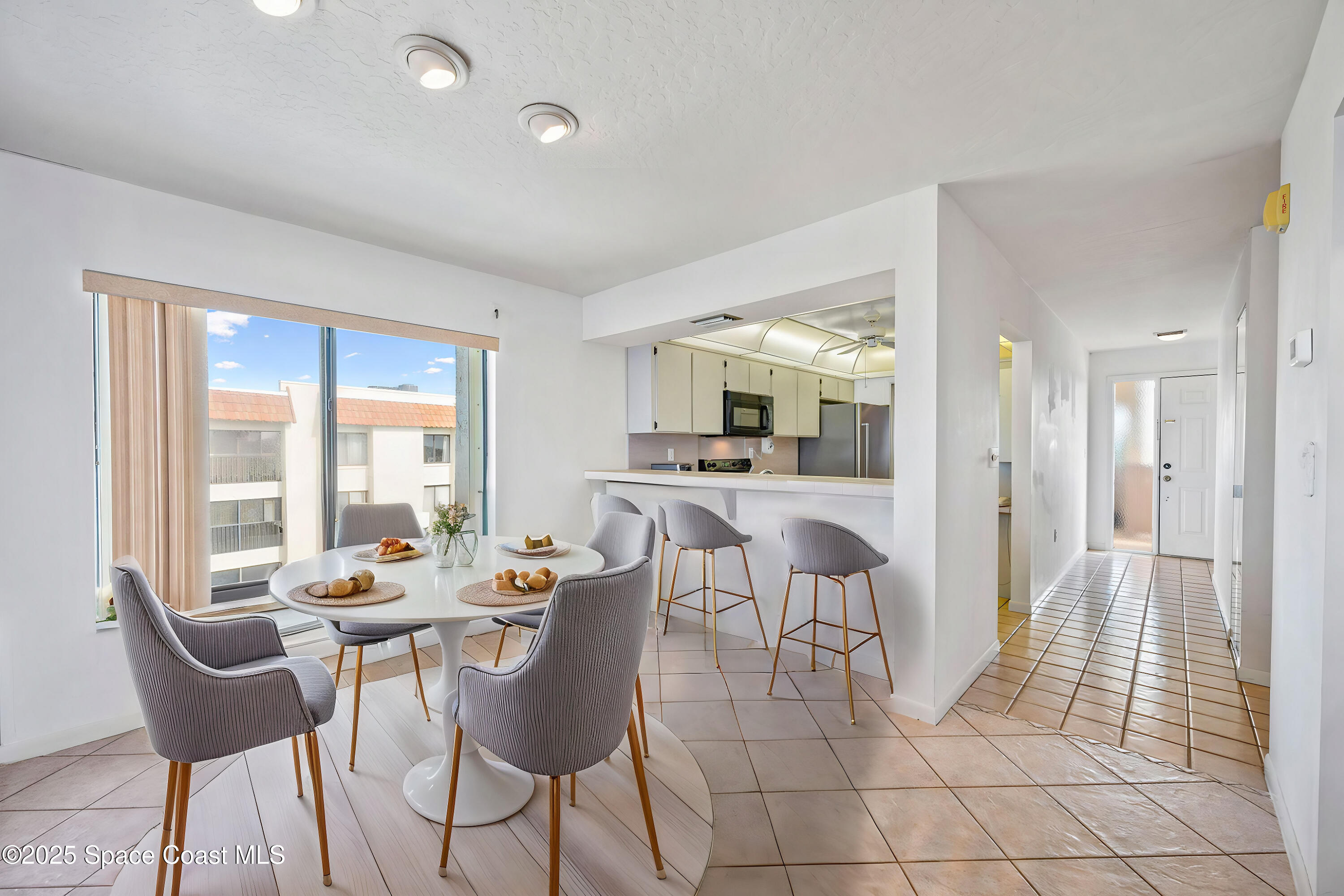 200 South Banana River Boulevard, Unit 2424 Cocoa Beach, FL 32931 - Photo 6 of 18 a view of a dining room with furniture and floor to ceiling window
