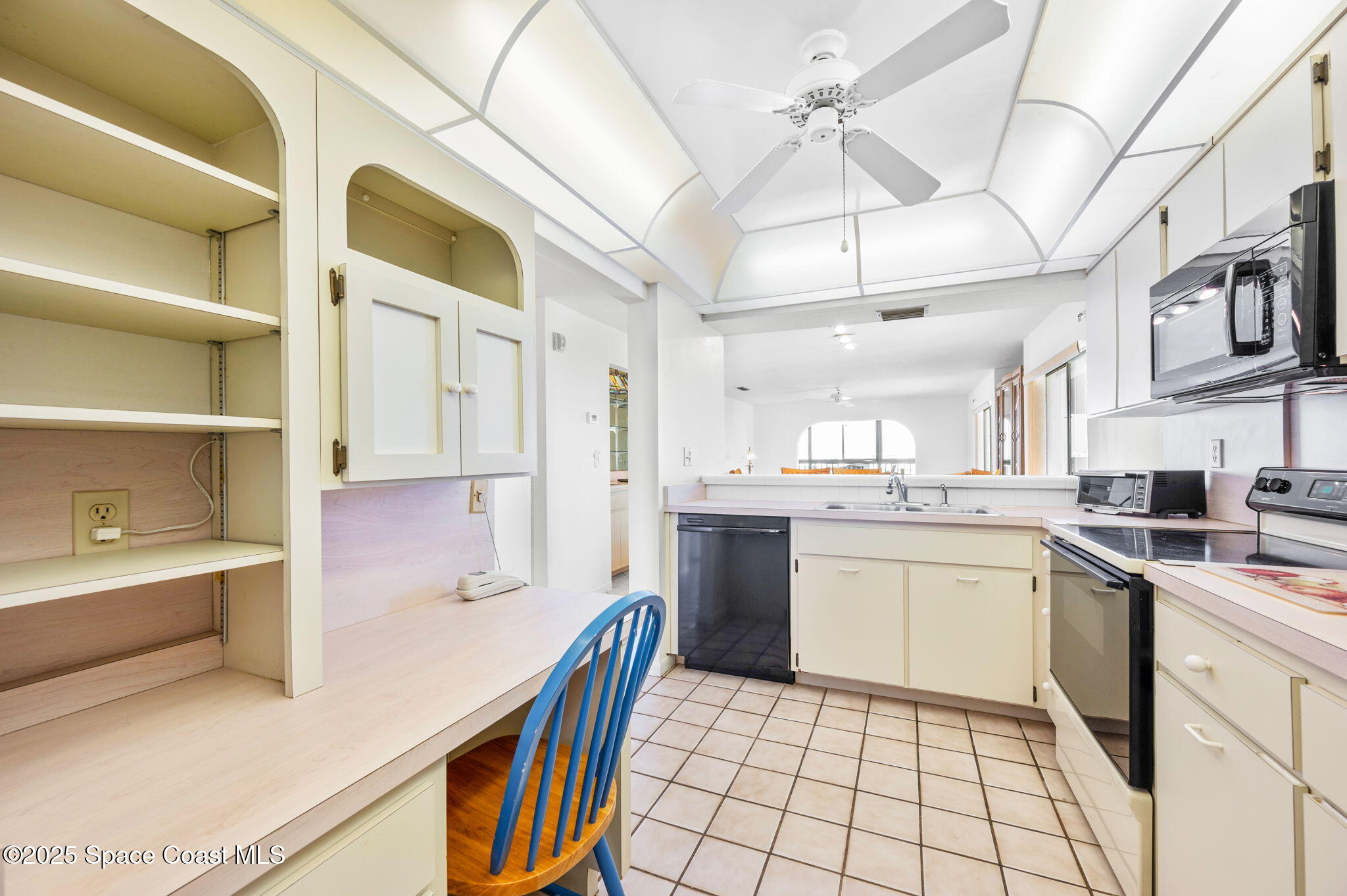 200 South Banana River Boulevard, Unit 2424 Cocoa Beach, FL 32931 - Photo 7 of 18 a kitchen with a sink cabinets and appliances