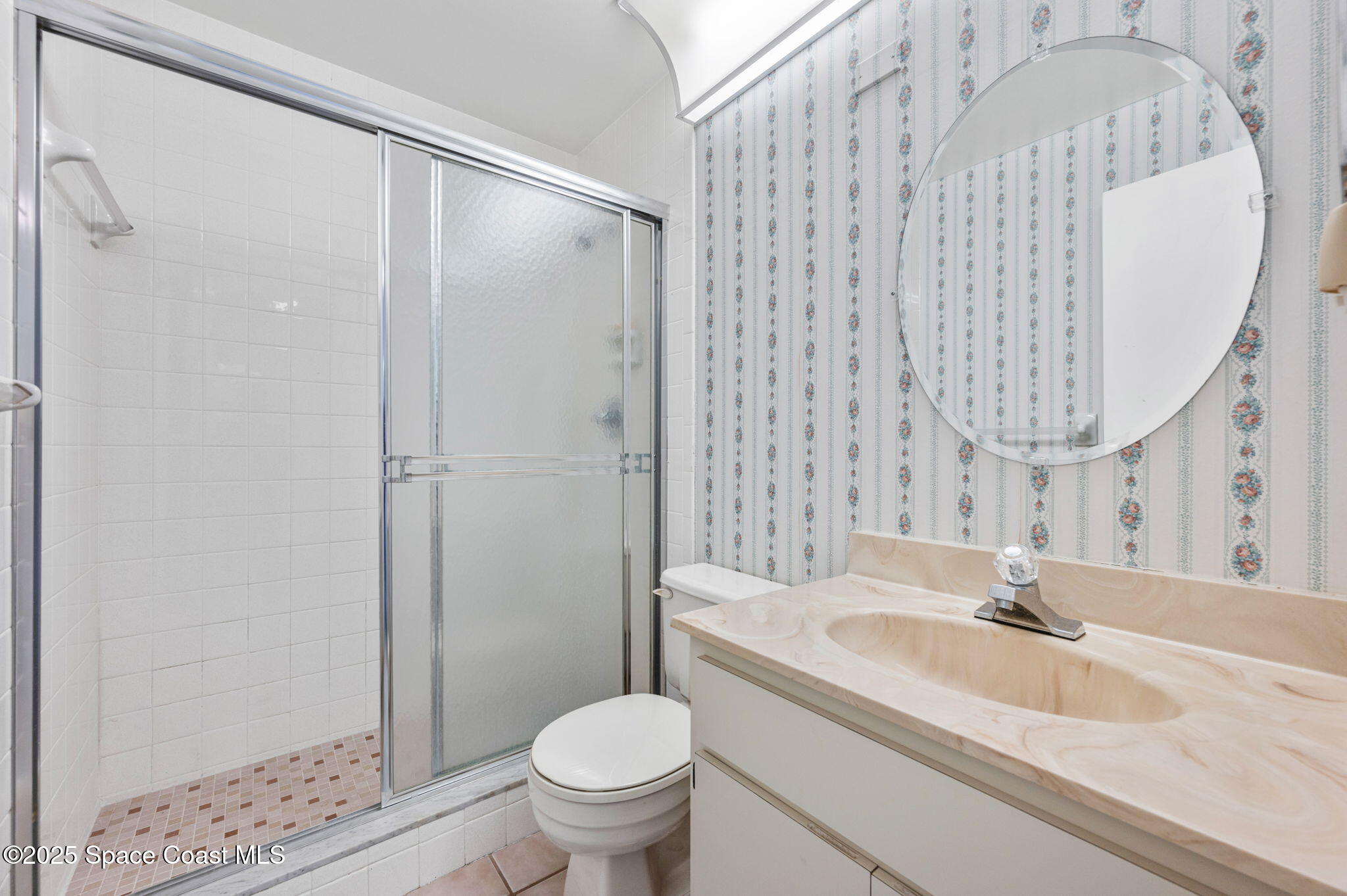 200 South Banana River Boulevard, Unit 2424 Cocoa Beach, FL 32931 - Photo 10 of 18 a bathroom with a sink and a mirror