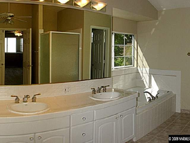 2332 Silver Ridge Drive Reno, NV 89509 - Photo 6 of 9 a bathroom with a sink and a mirror