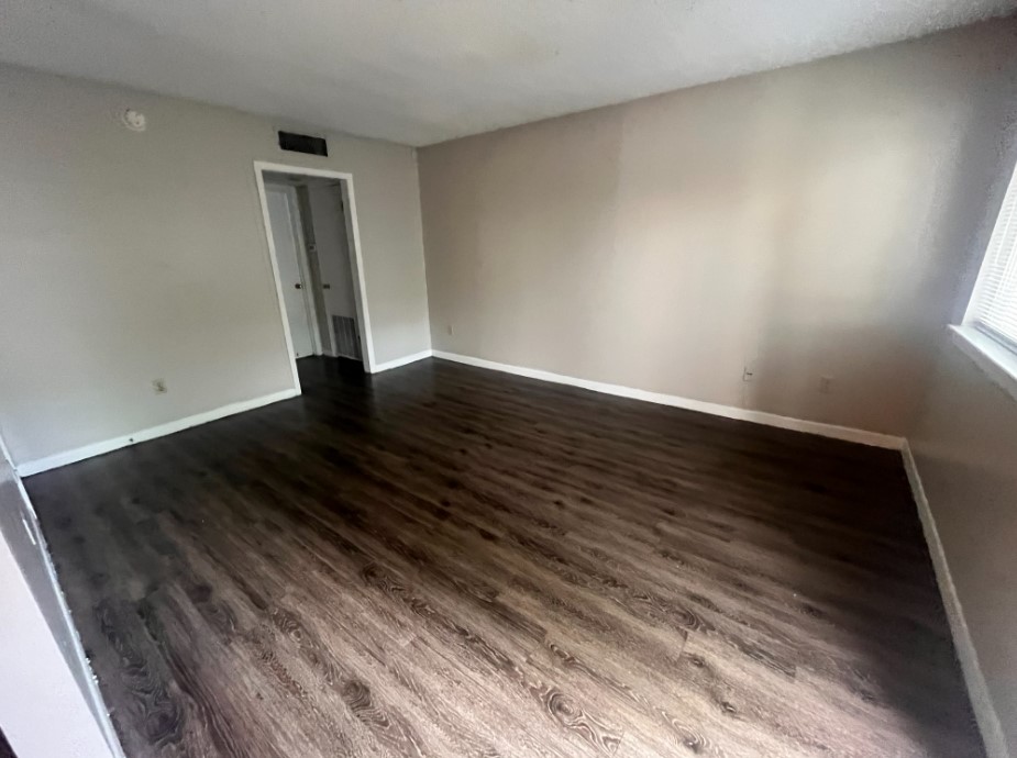 3106 Duval Street, Unit 306 Austin, TX 78705 - Photo 2 of 12 a view of an empty room and wooden floor