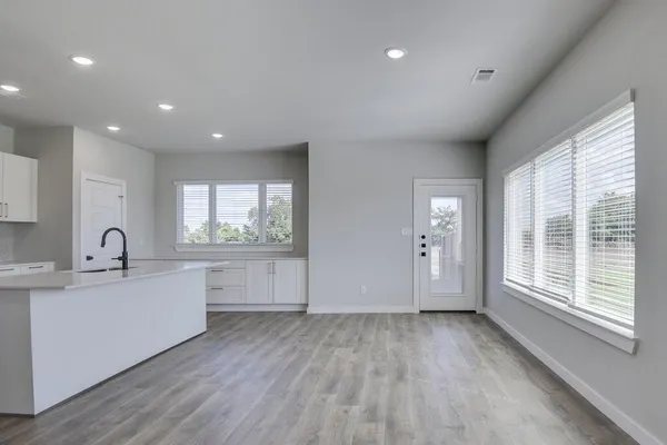 a kitchen with a sink stove and cabinets