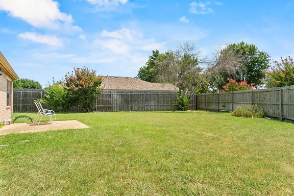 a view of backyard with trampoline