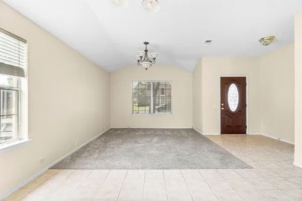 an empty room with windows and closet