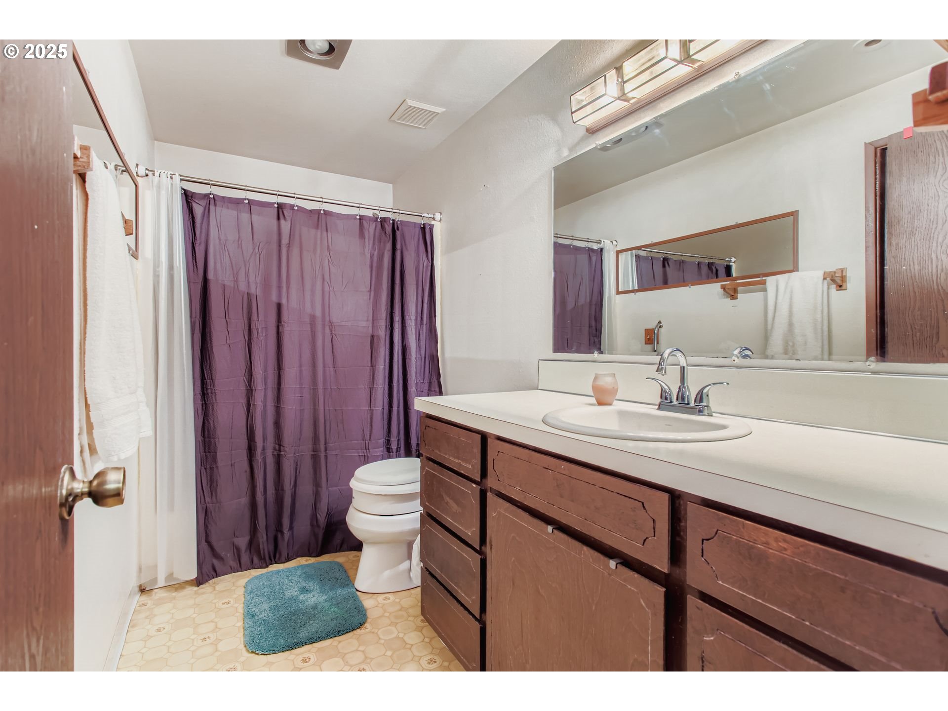 4201 Southwest Childs Road Lake Oswego, OR 97034 - Photo 12 of 37 a bathroom with a sink a toilet and a mirror
