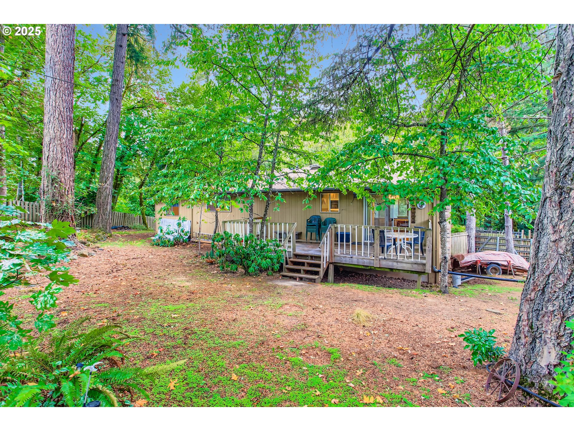 4201 Southwest Childs Road Lake Oswego, OR 97034 - Photo 22 of 37 a view of a chair and tables in the garden in front of a house