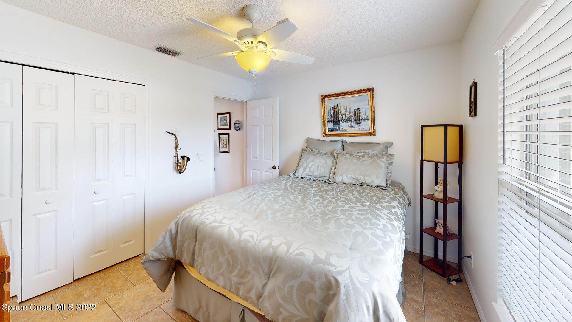 6801 Cecil Road Cocoa, FL 32927 - Photo 13 of 66 a bedroom with a bed and a chandelier