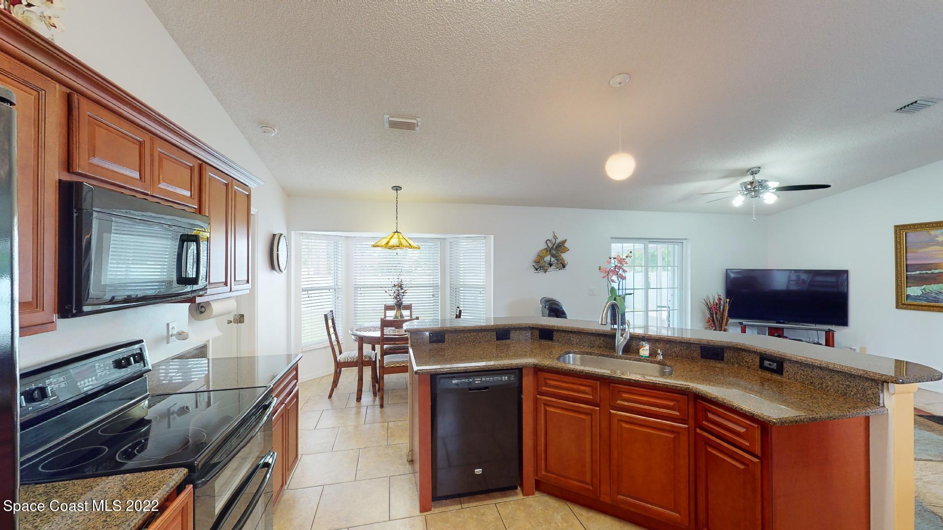 6801 Cecil Road Cocoa, FL 32927 - Photo 23 of 66 a kitchen with lots of counter top space and stainless steel appliances