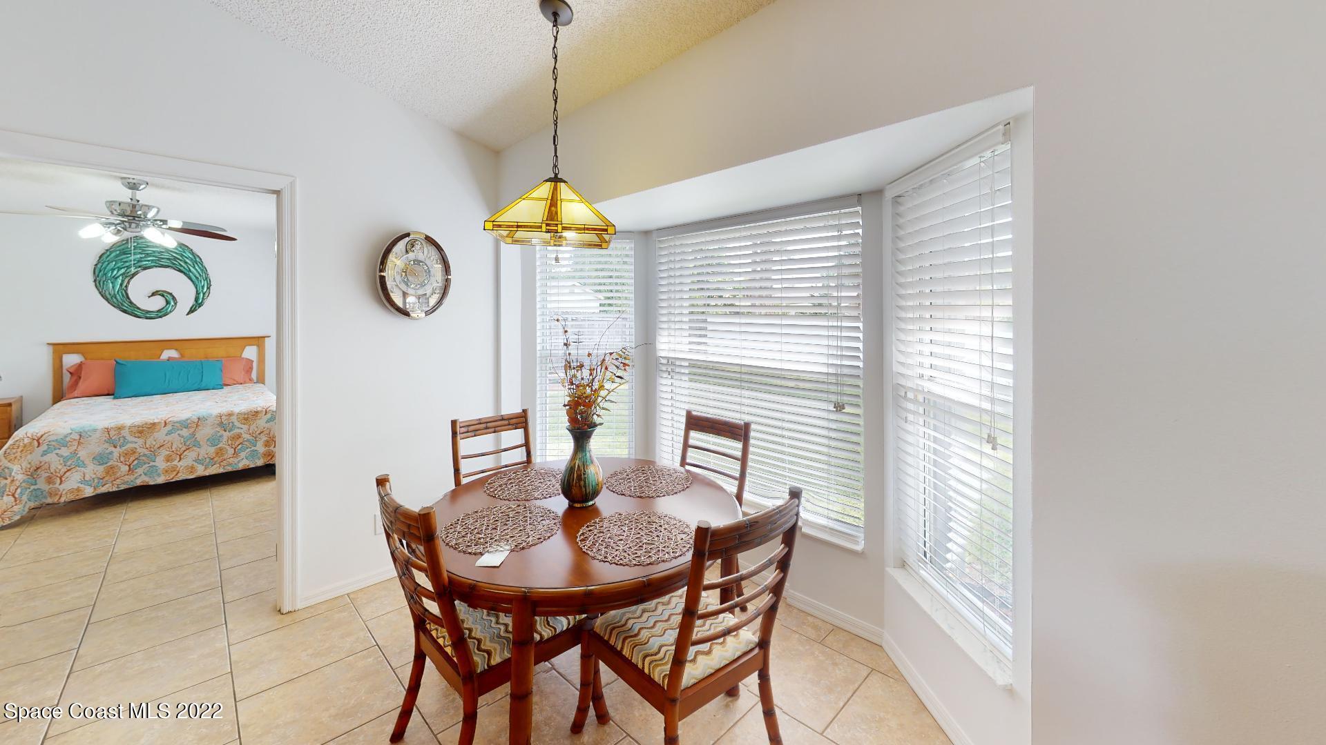 6801 Cecil Road Cocoa, FL 32927 - Photo 33 of 66 a view of a dining room and livingroom with furniture wooden floor a chandelier