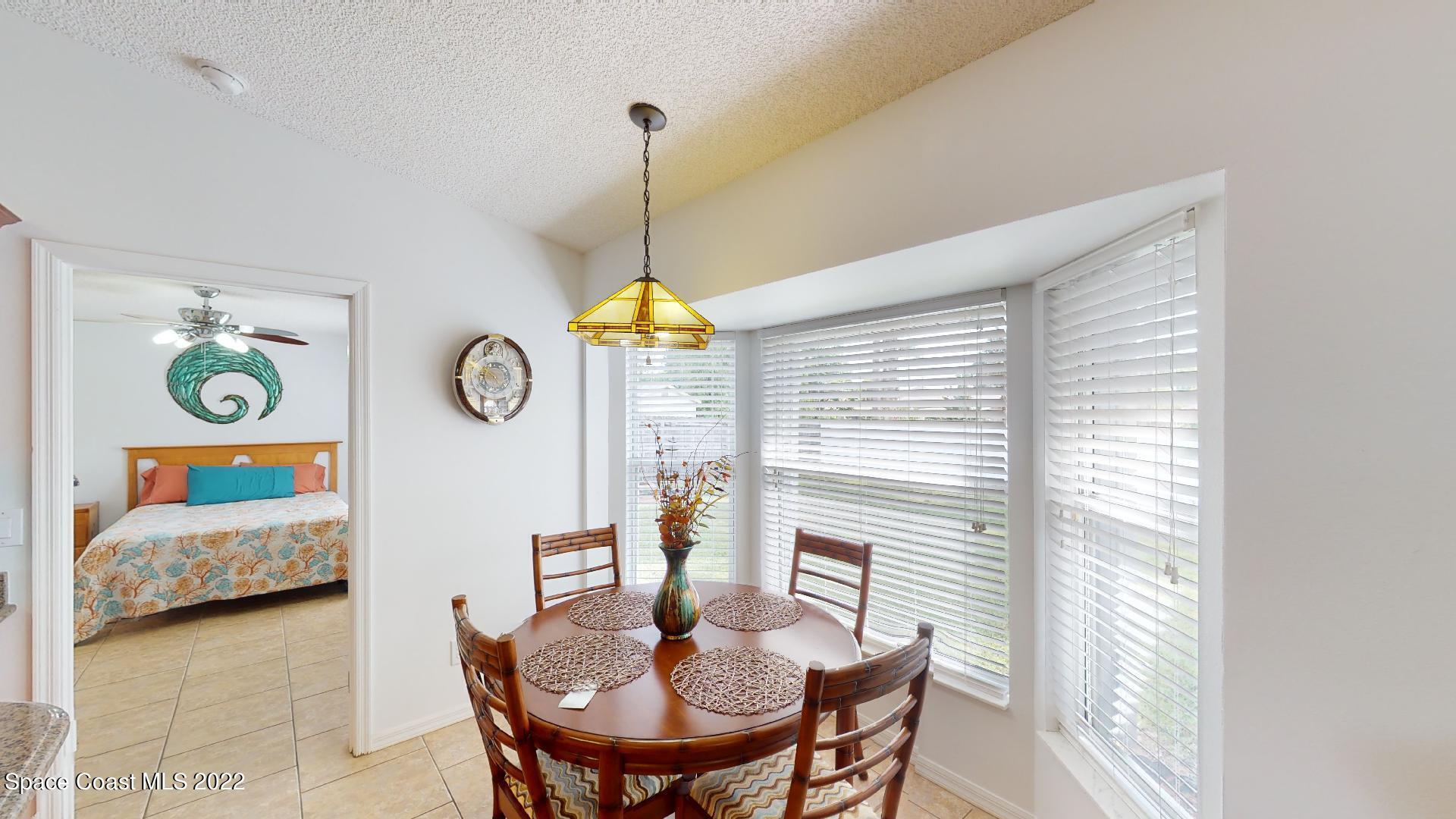 6801 Cecil Road Cocoa, FL 32927 - Photo 36 of 66 a view of a dining room with furniture and chandelier