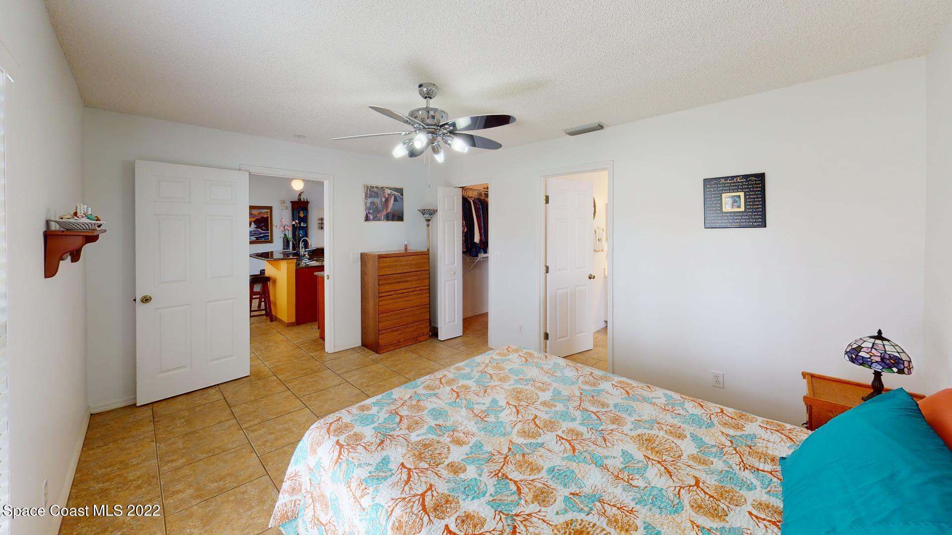 6801 Cecil Road Cocoa, FL 32927 - Photo 39 of 66 a bedroom with a bed and a chandelier