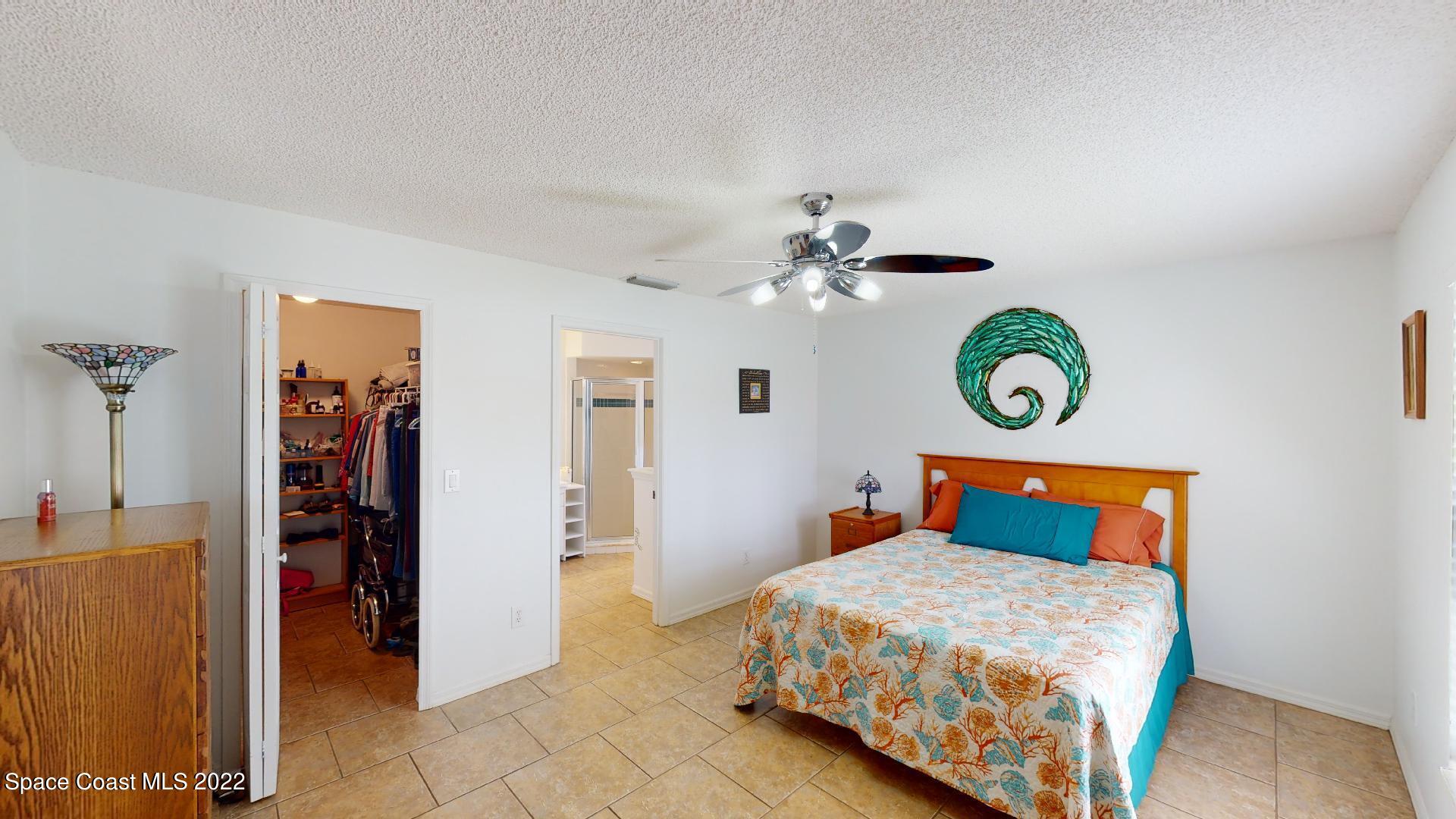 6801 Cecil Road Cocoa, FL 32927 - Photo 41 of 66 a bedroom with a bed and painting on the wall