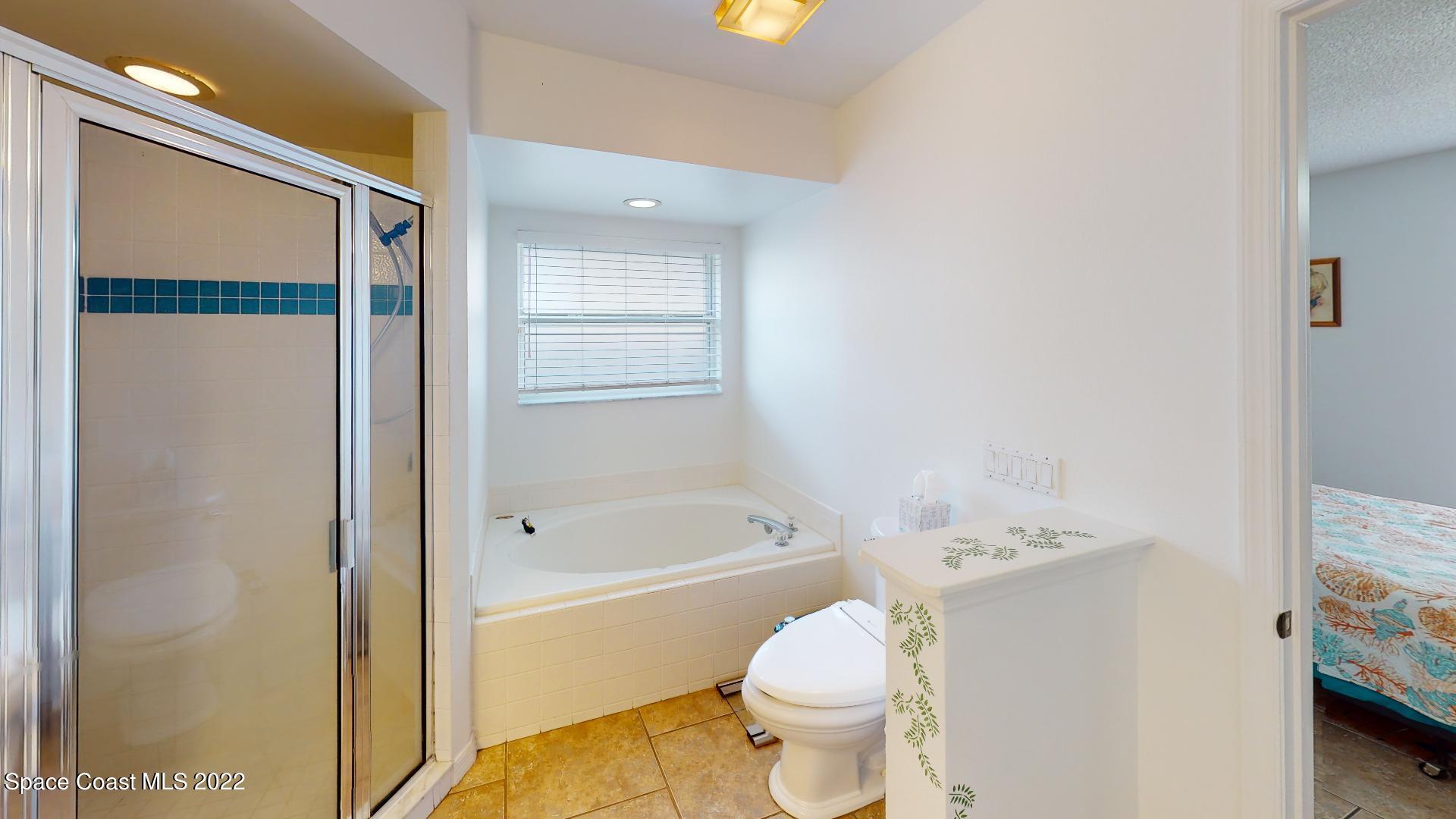 6801 Cecil Road Cocoa, FL 32927 - Photo 44 of 66 a bathroom with a toilet sink and shower