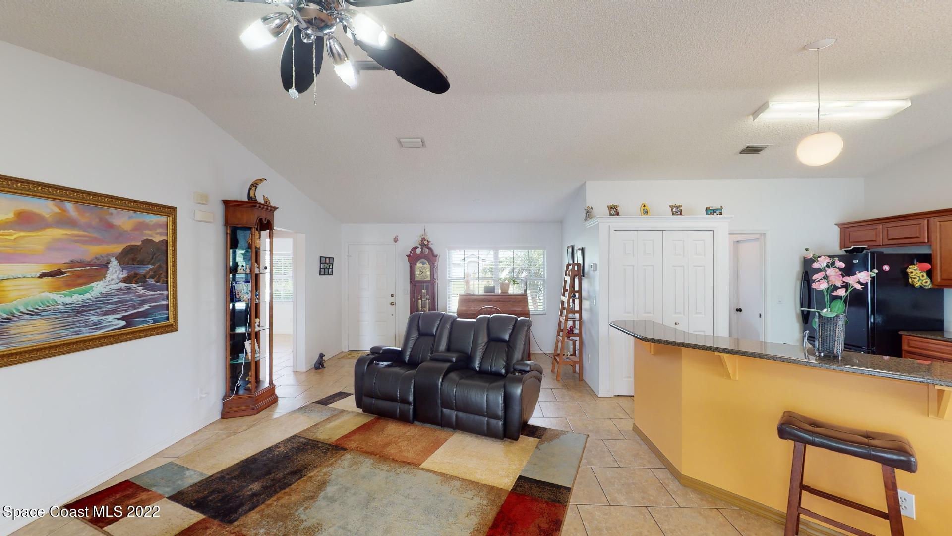 6801 Cecil Road Cocoa, FL 32927 - Photo 46 of 66 a living room with furniture and a flat screen tv