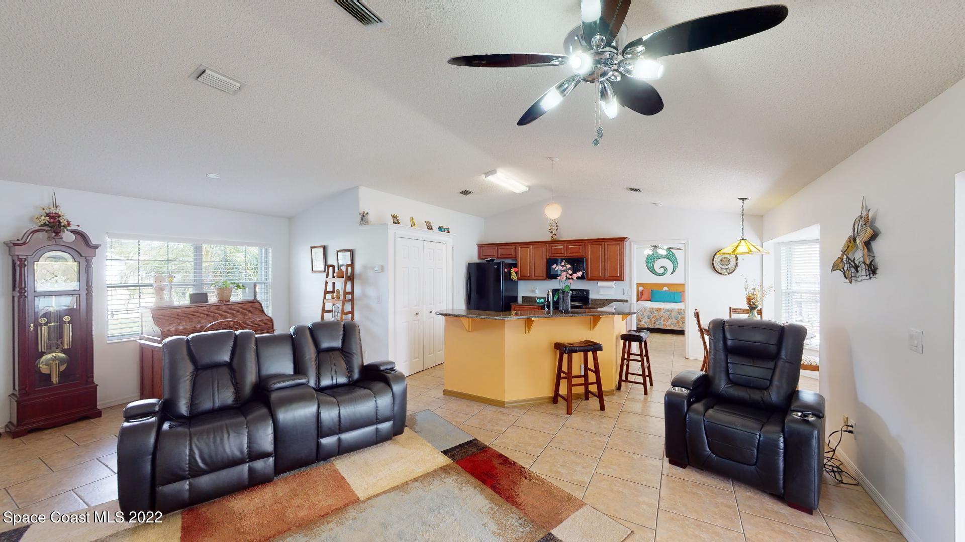 6801 Cecil Road Cocoa, FL 32927 - Photo 47 of 66 a living room with furniture kitchen view and a window