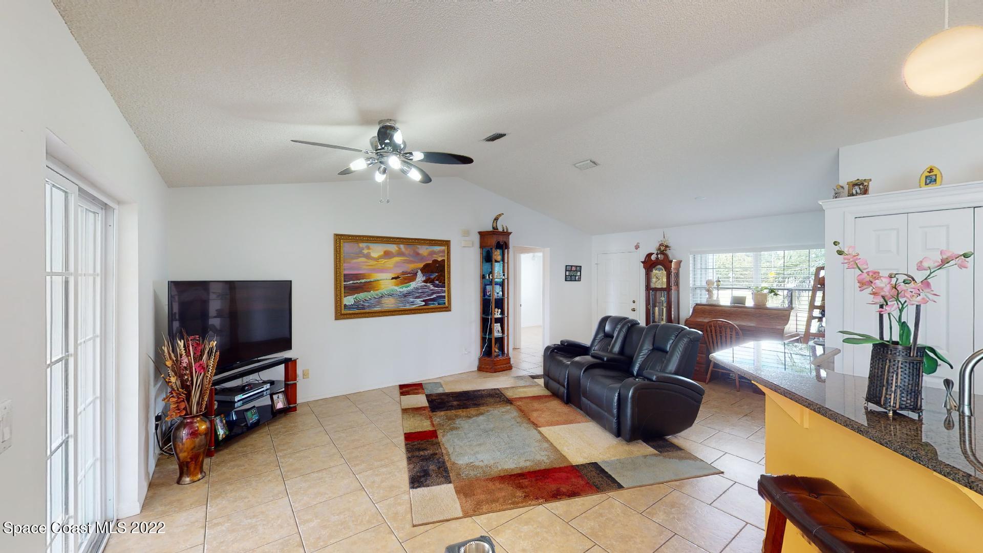 6801 Cecil Road Cocoa, FL 32927 - Photo 48 of 66 a living room with furniture and a flat screen tv