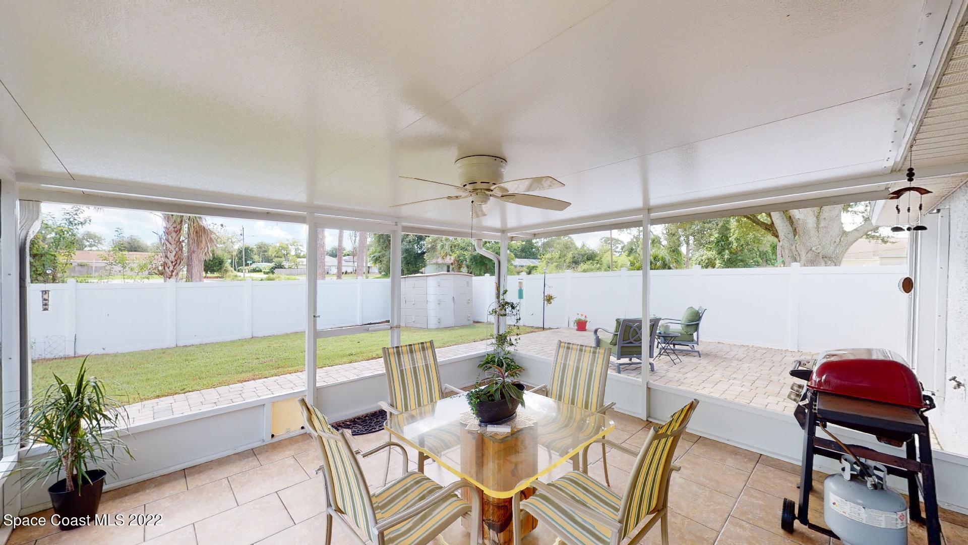 6801 Cecil Road Cocoa, FL 32927 - Photo 50 of 66 a dining room with furniture and a floor to ceiling window
