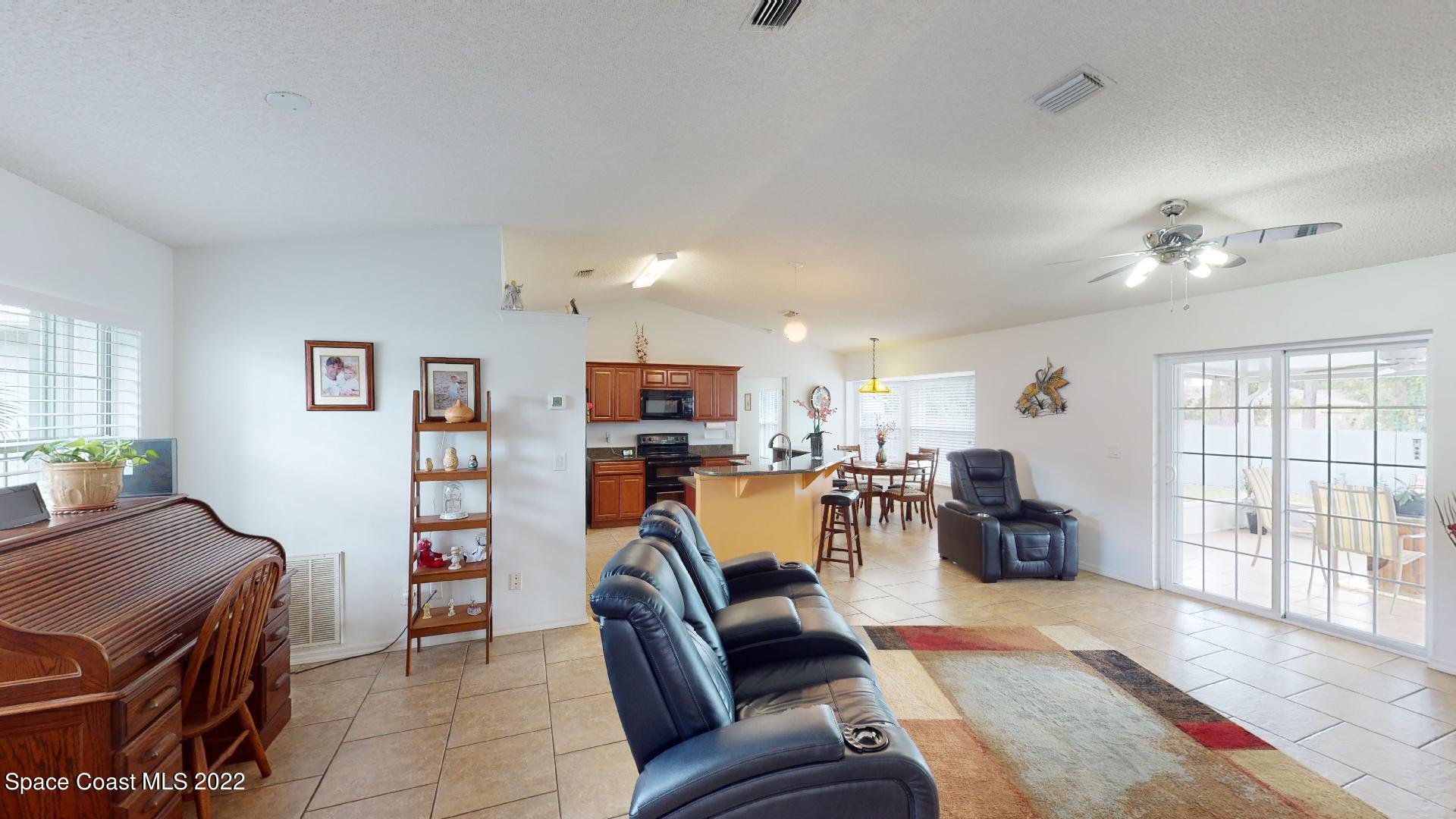 6801 Cecil Road Cocoa, FL 32927 - Photo 5 of 66 a living room with furniture and a flat screen tv