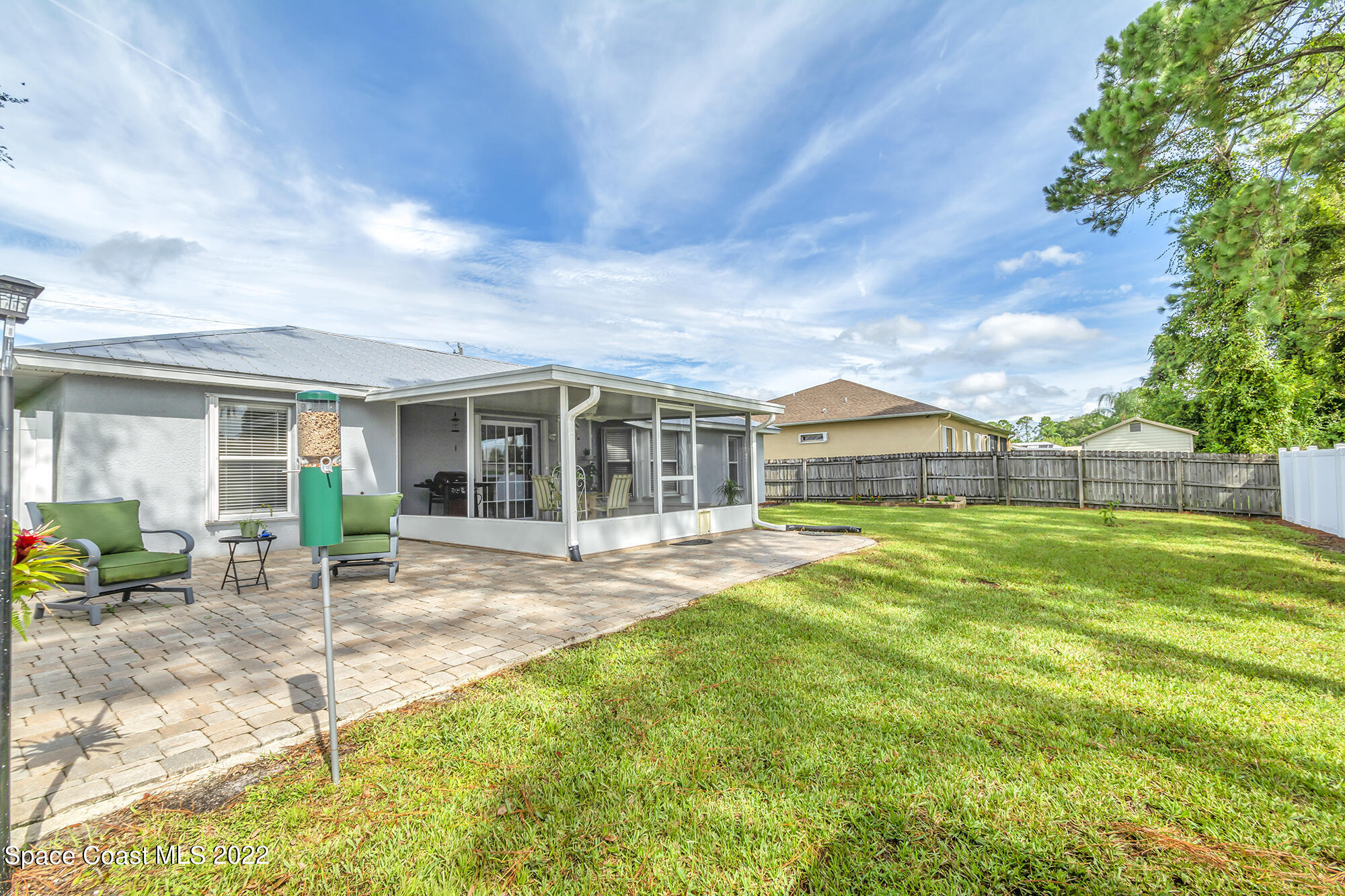 6801 Cecil Road Cocoa, FL 32927 - Photo 56 of 66 a view of a house with a backyard and a patio