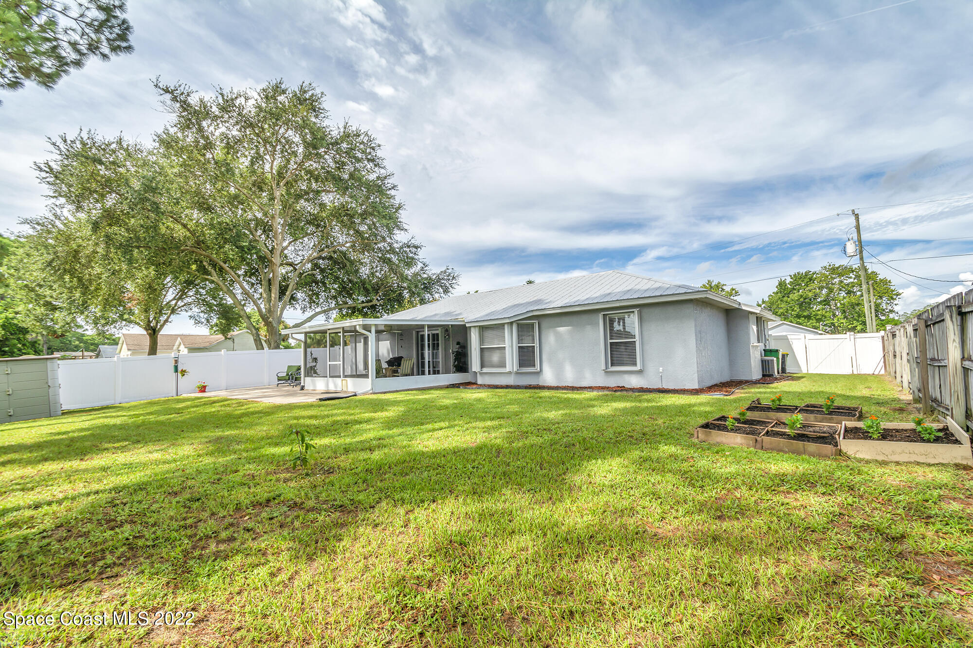 6801 Cecil Road Cocoa, FL 32927 - Photo 60 of 66 a front view of a house with a yard