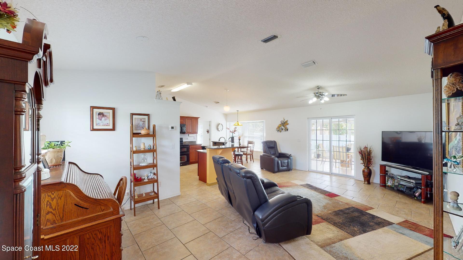 6801 Cecil Road Cocoa, FL 32927 - Photo 6 of 66 a living room with furniture and a flat screen tv