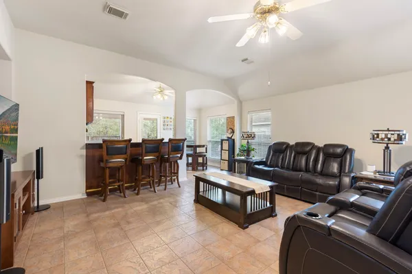 a living room with furniture a dining table and a flat screen tv