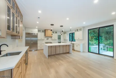 a large kitchen with a lot of counter space and a sink