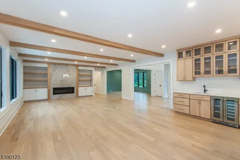 an empty room with closet and windows