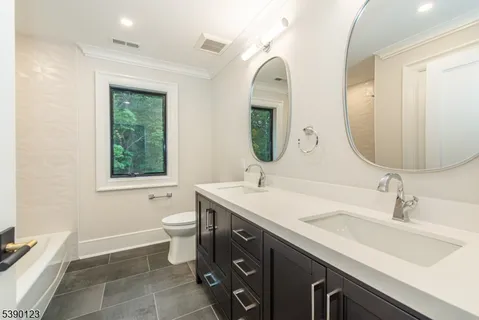 a bathroom with a double vanity sink and a mirror