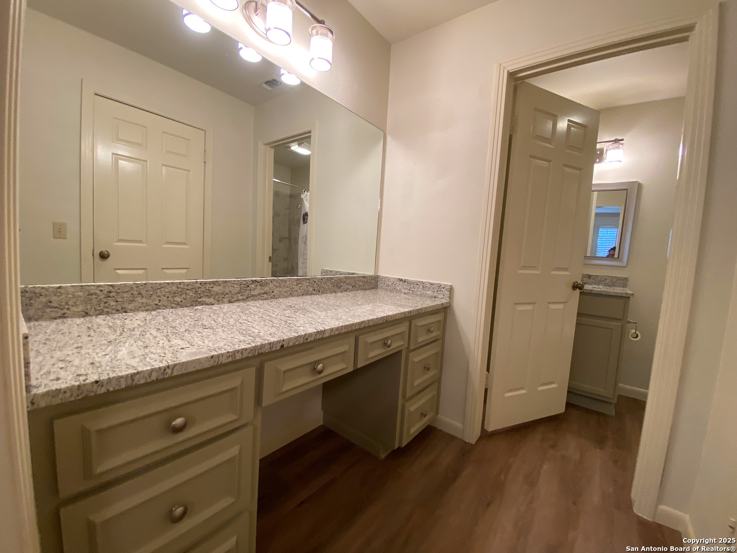 165 West Rampart Drive, Unit 205 San Antonio, TX 78216 - Photo 27 of 34 a bathroom with a granite countertop sink and a mirror