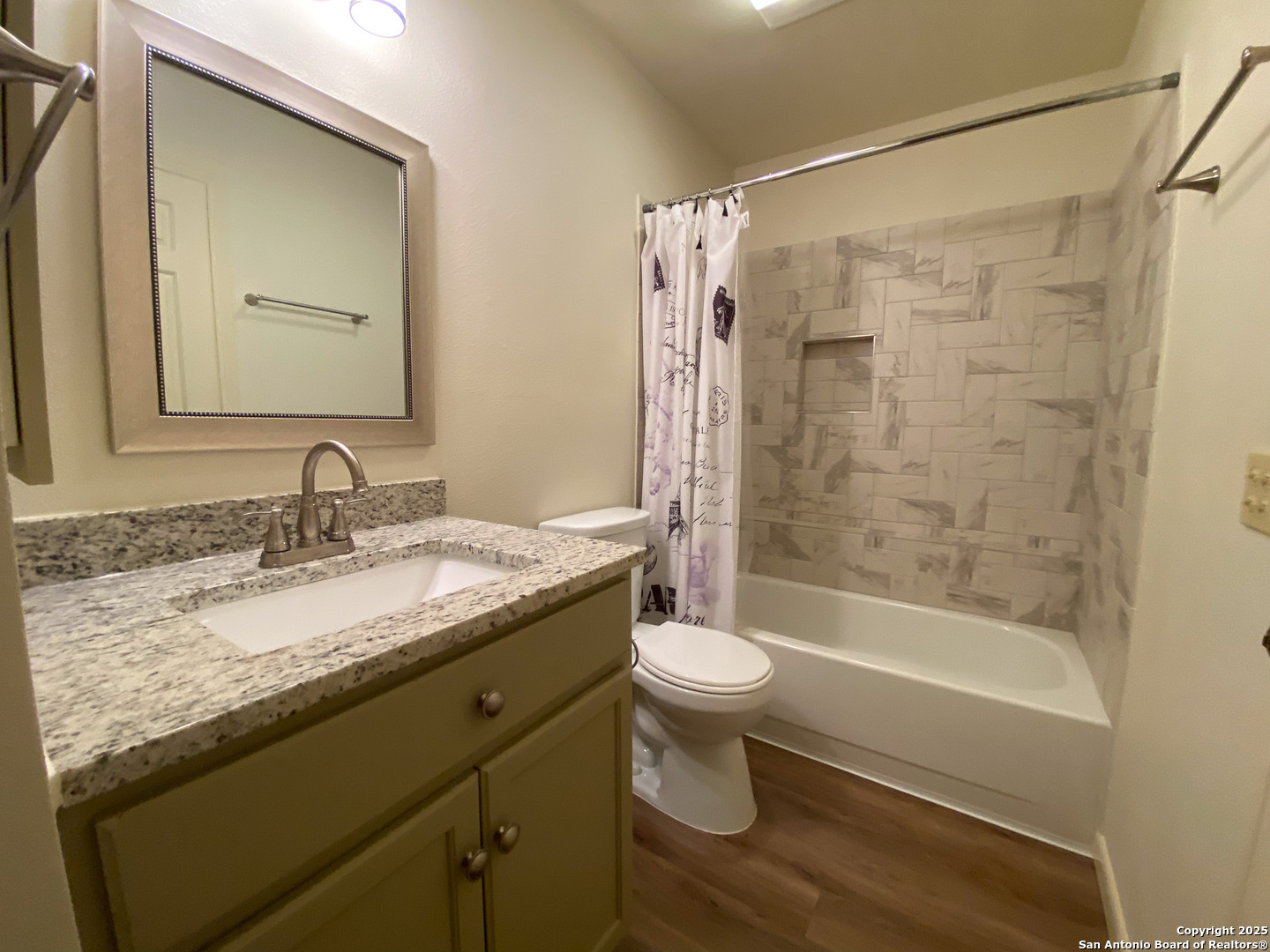 165 West Rampart Drive, Unit 205 San Antonio, TX 78216 - Photo 28 of 34 a bathroom with a granite countertop sink toilet a mirror a bathtub and shower