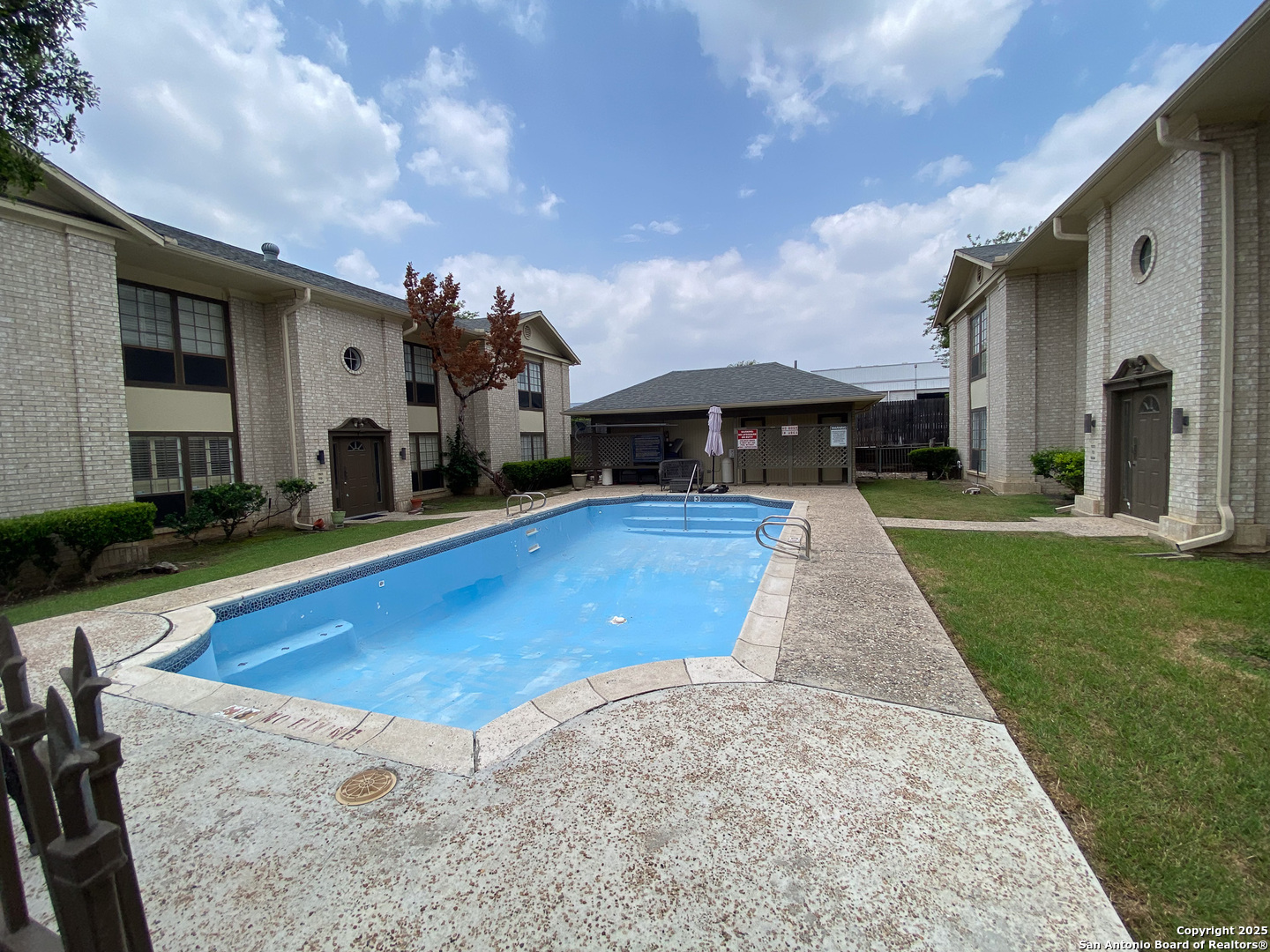 165 West Rampart Drive, Unit 205 San Antonio, TX 78216 - Photo 7 of 34 a view of a house with swimming pool and a yard