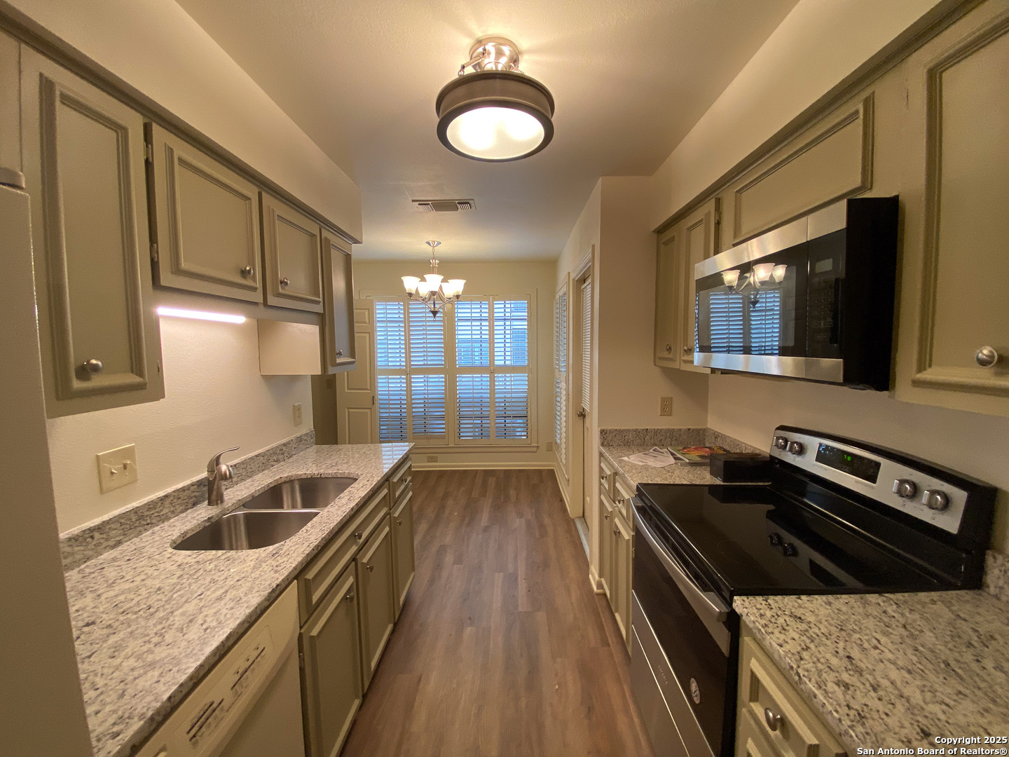 165 West Rampart Drive, Unit 205 San Antonio, TX 78216 - Photo 10 of 34 a kitchen that has a sink and a stove