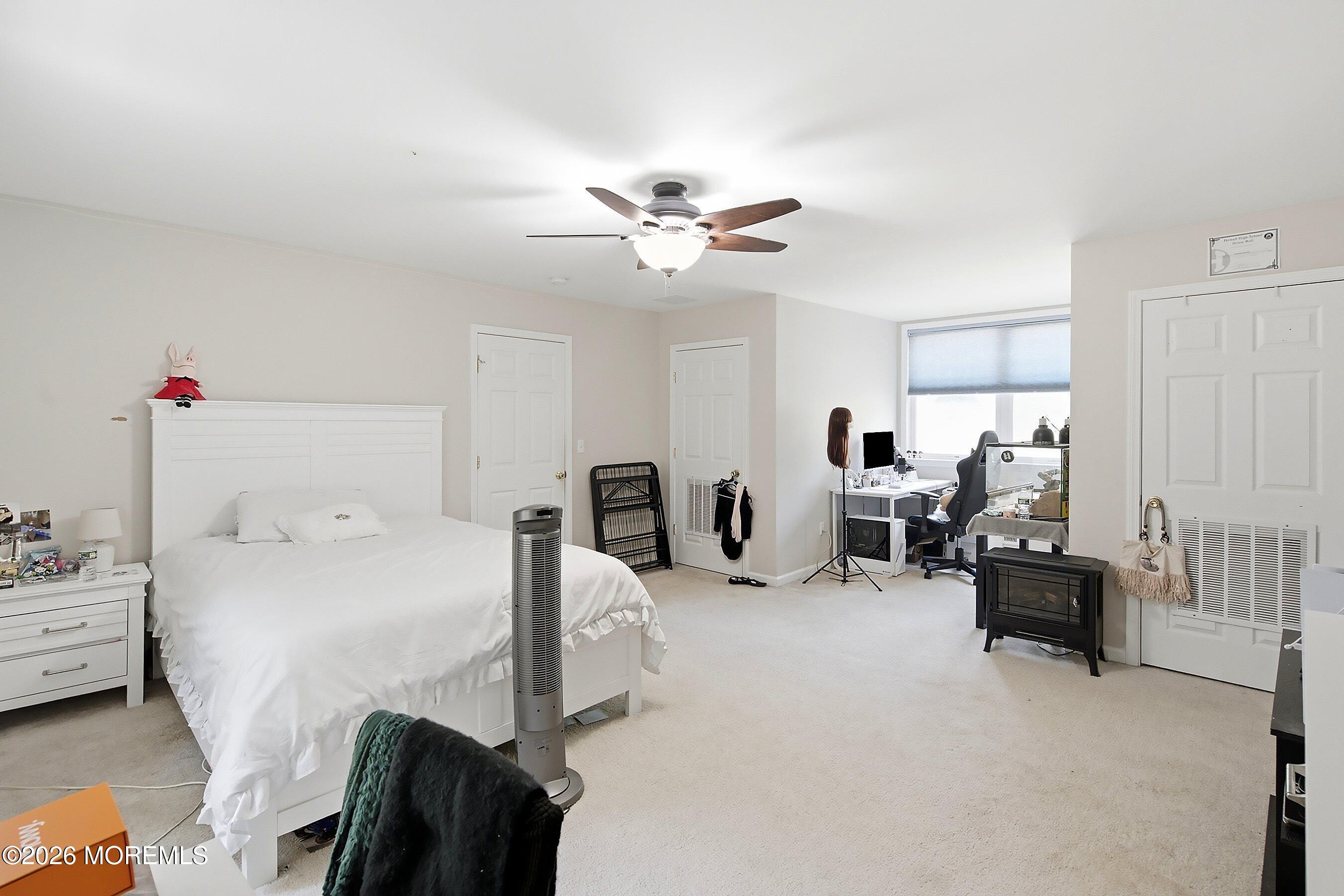 935 Bethel Church Road Jackson, NJ 08527 - Photo 19 of 32 a bed room with bed and a chandelier
