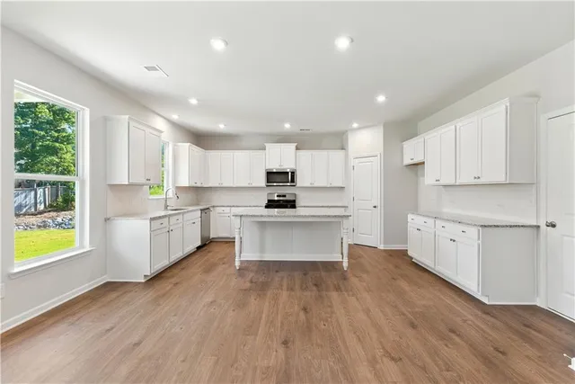 a kitchen with wooden floors and white appliances