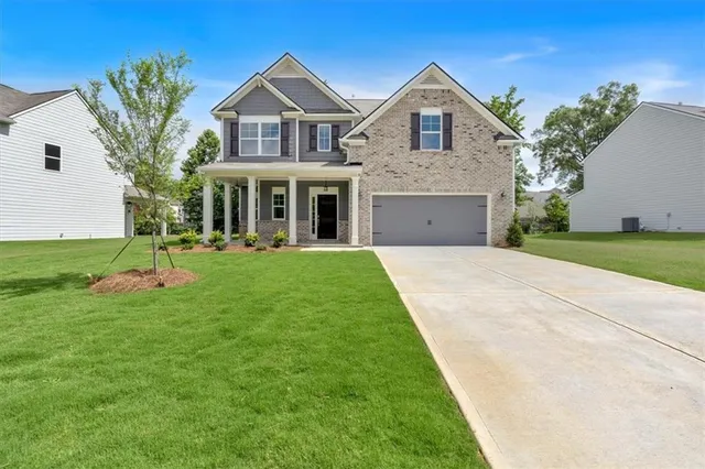 a front view of a house with a yard and garage