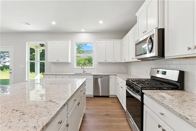 a kitchen that has a sink a stove and a refrigerator
