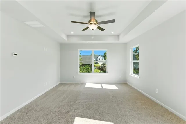 an empty room with closet and windows