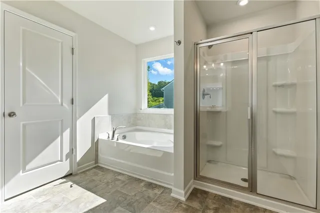 a spacious bathroom with a double vanity sink a mirror and a shower
