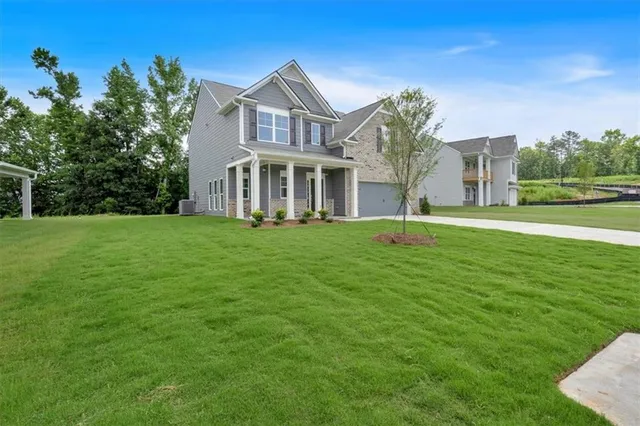 a front view of a house with a garden