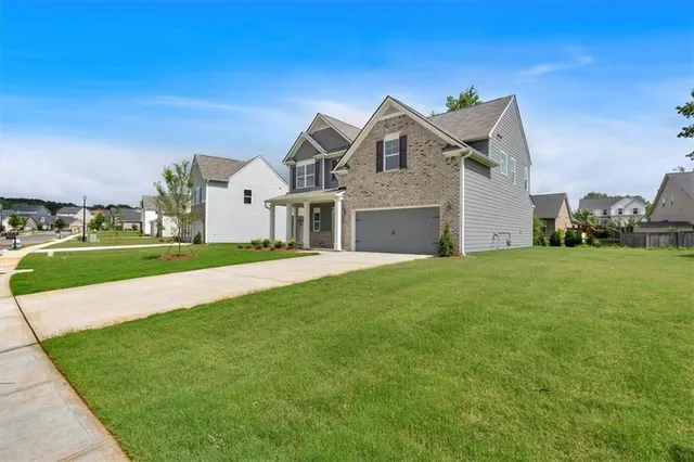 a front view of a house with a yard and garage