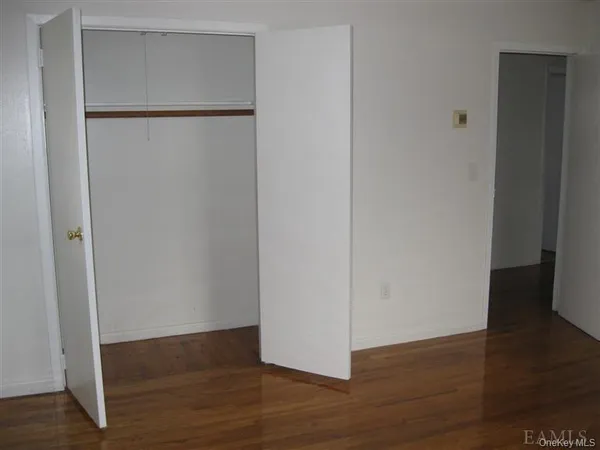 an empty room with wooden floor