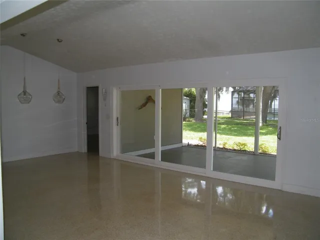 a view of an empty room with windows