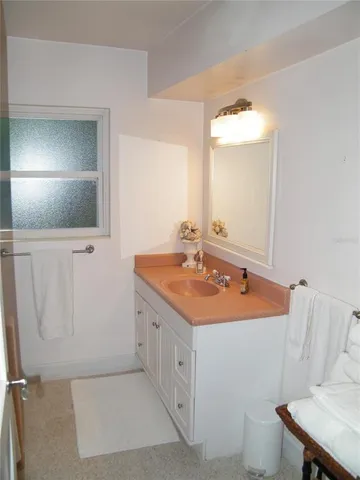 a spacious bathroom with a sink a toilet and mirror