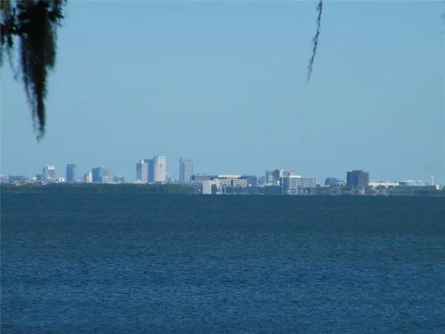 a view of an ocean beach and mountain