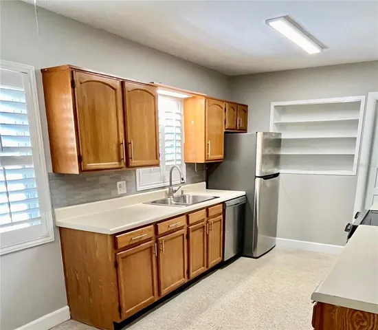 a kitchen with a sink stove and cabinets